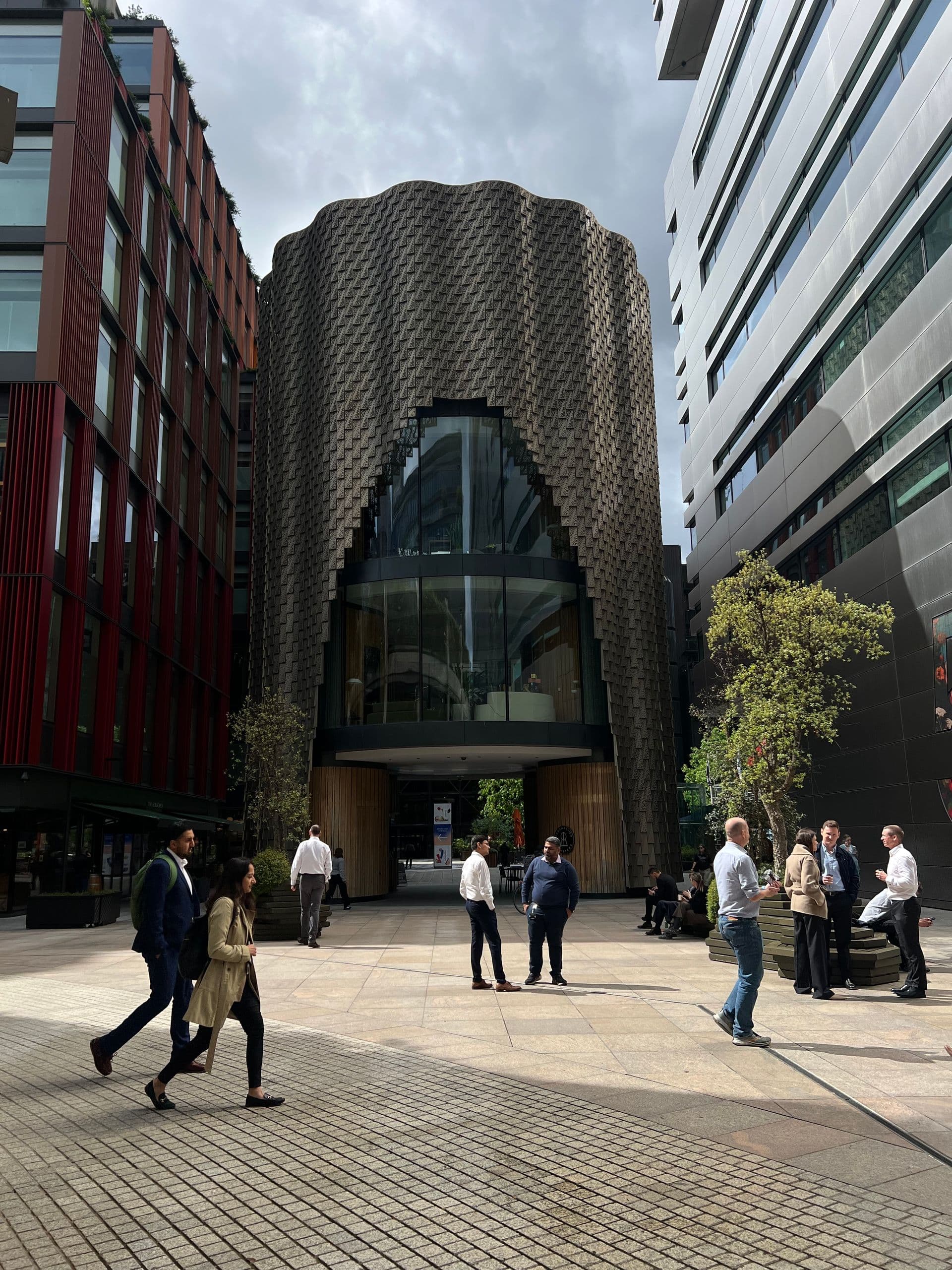 People walking past a modern office building in central London